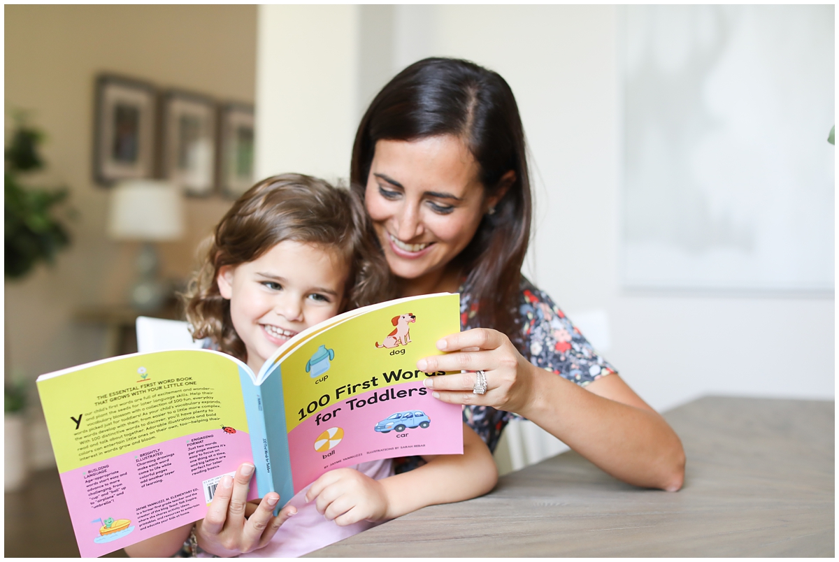 Mom daughter reading book together